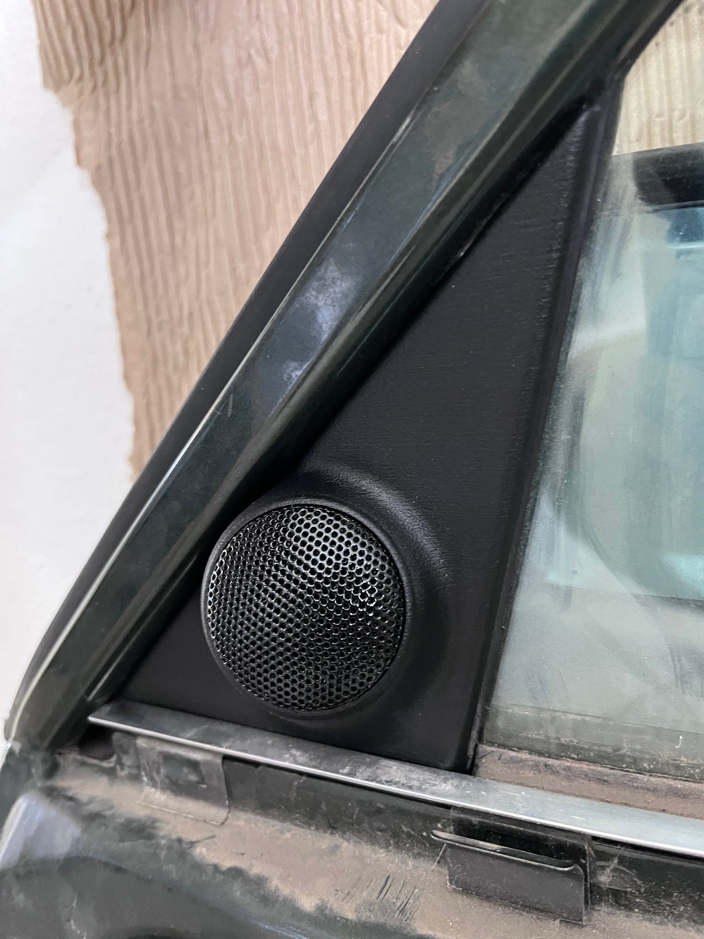 BMW E30 tweeter mirror triangle cover installed on door, OEM appearance restored