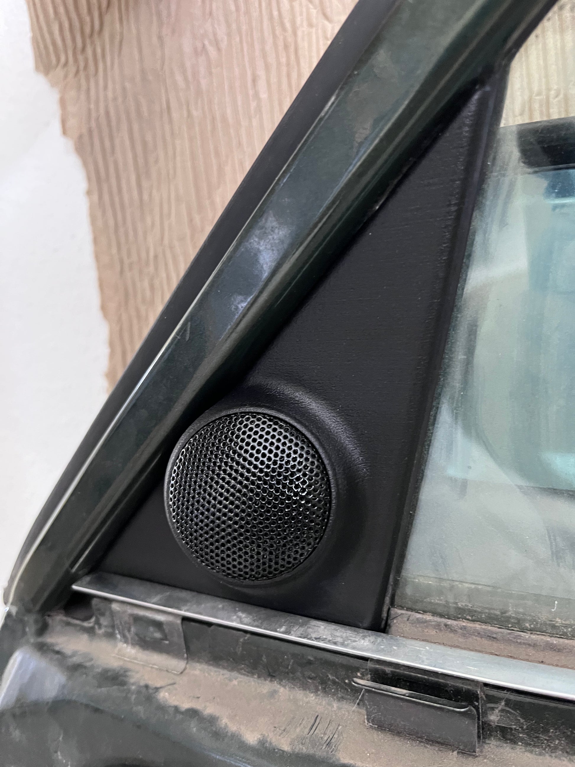BMW E30 tweeter mirror triangle cover installed on door, OEM appearance restored